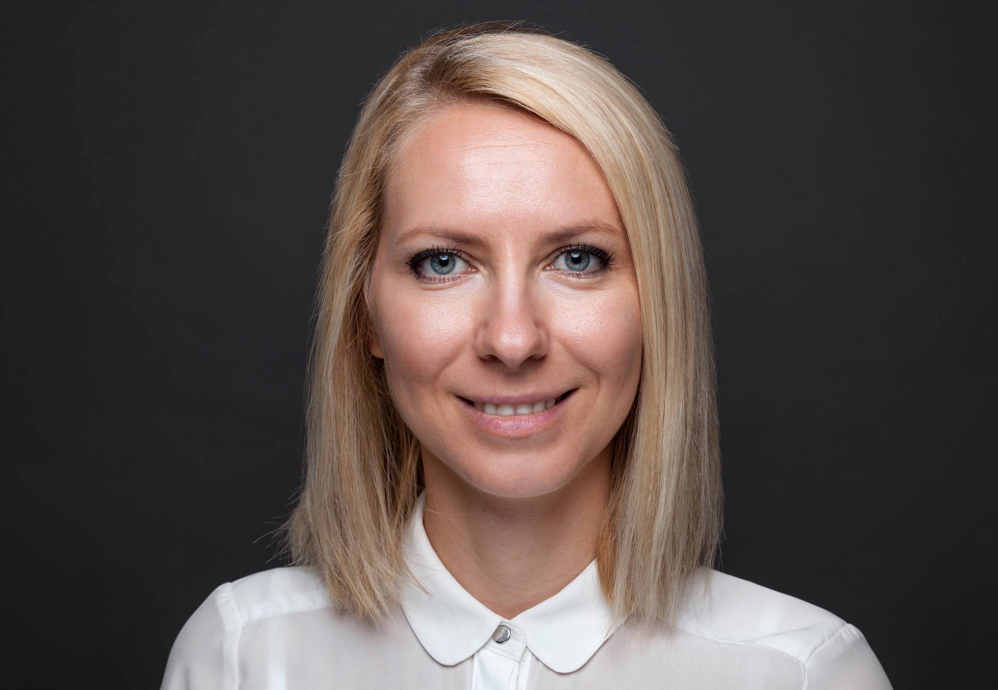 Headshot of young and happy business woman